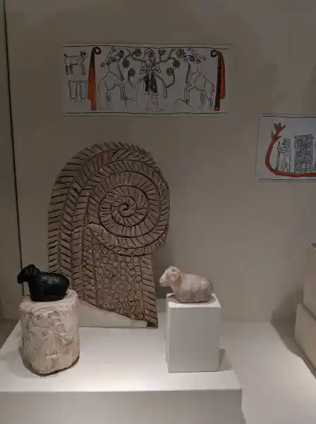 Seal, two so-called bundles of reed rings, symbols of the goddess Inana, frame the feeding of caprids by a high dignitary